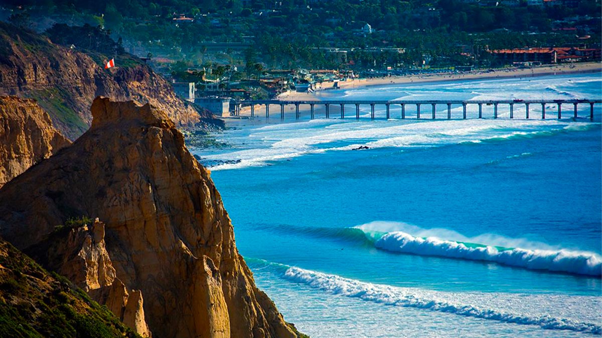 aerial of Blacks Beach La Jolla on a sunny day with waves crashing in San Diego, California, USA